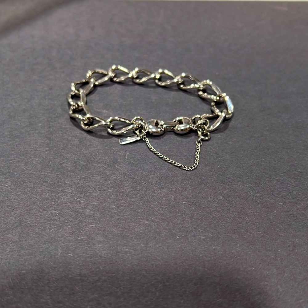 Monet bracelet silver tone .  Stamped Monet on safety chain and clasp.